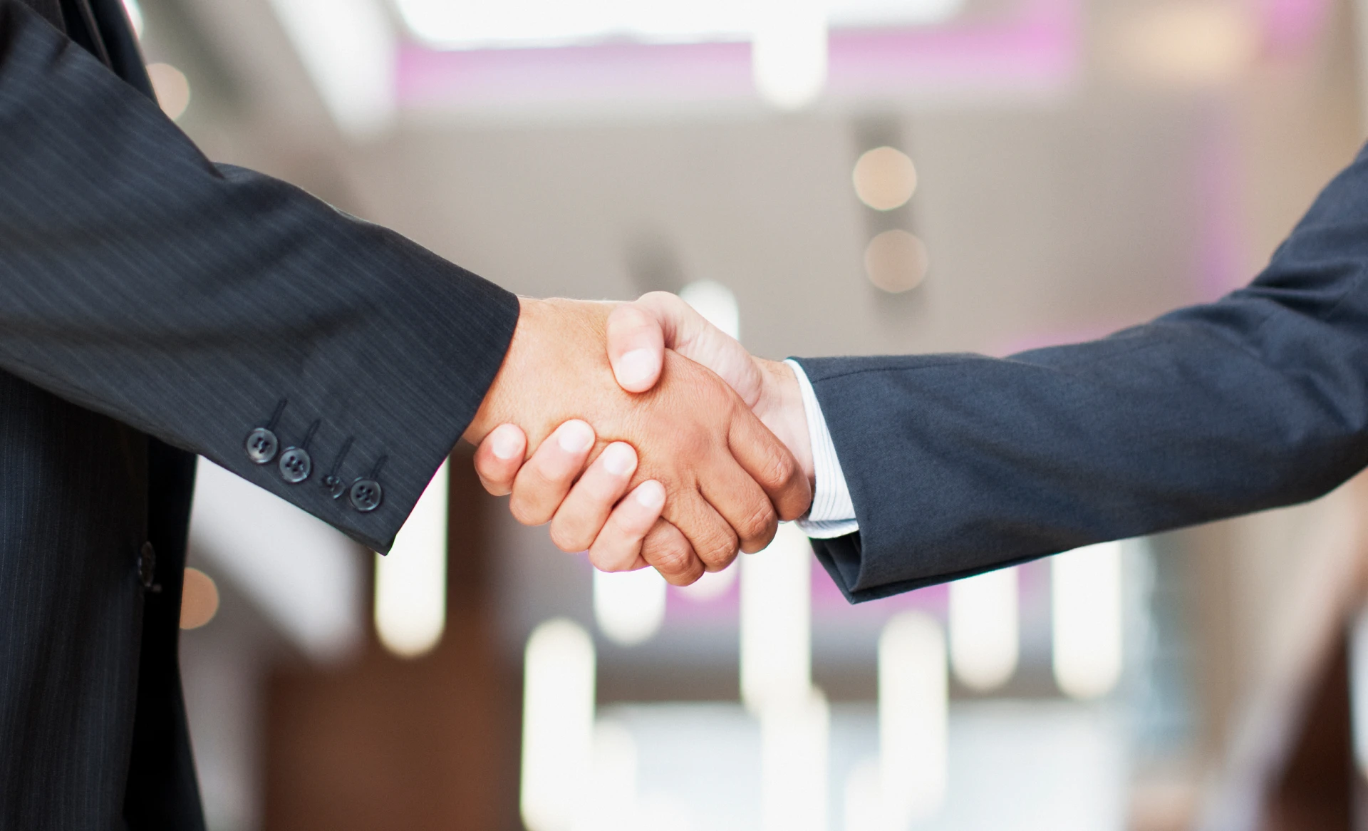 Two people shaking hands indoors