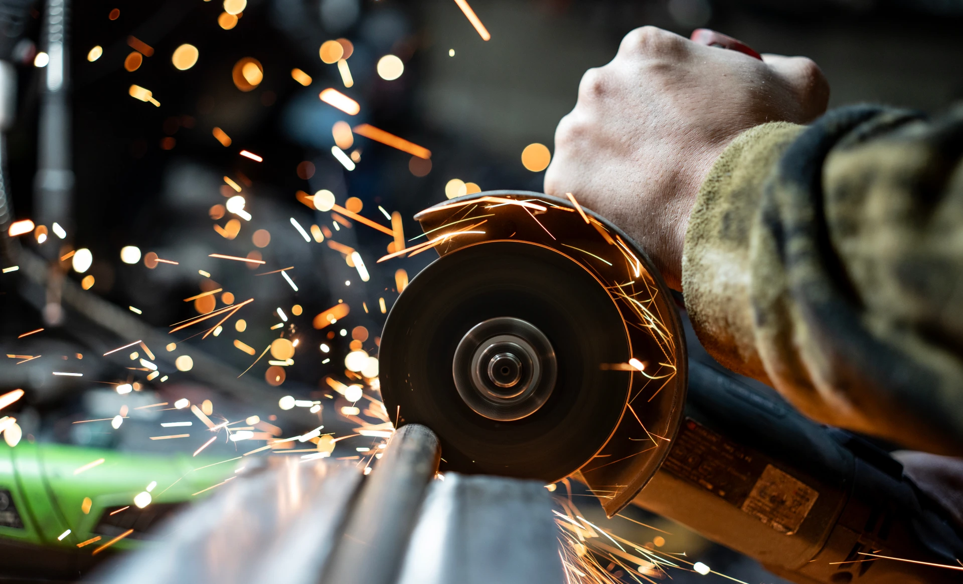 Grinding metal, creating bright orange sparks
